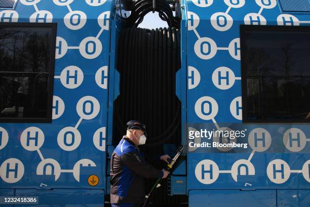 Worker refuels a Coradia iLint hydrogen fuel cell powered railway train, manufactured by Alstom SA, in Salzgitter, Germany, on Tuesday, April 20,...