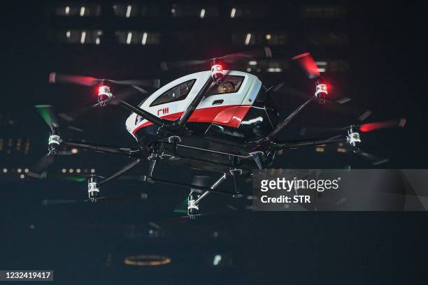 Drone flies into the arena with a passenger in the back carrying the Chinese Super League trophy before the CSL football match between Guangzhou FC...