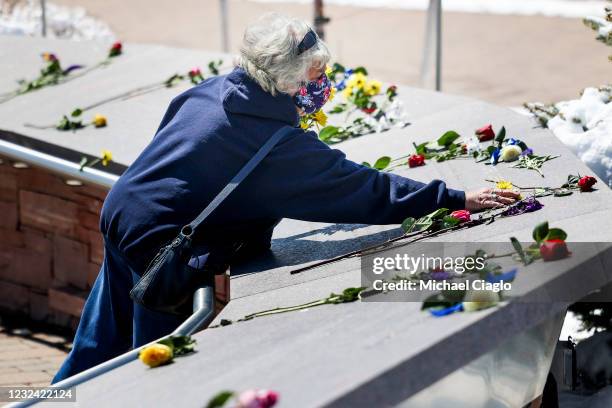 Woman leaves flowers at the Columbine Memorial next to Columbine High School on April 20, 2021 in Littleton, Colorado. Twelve students and a teacher...