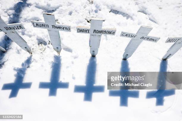 Crosses with the names of the victims of the Columbine High School shooting sit next to the Columbine Memorial on April 20, 2021 in Littleton,...