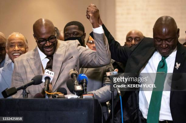 Attorney Ben Crump and Philonise Floyd hold hands during a press conference following the verdict in the trial of former police officer Derek Chauvin...