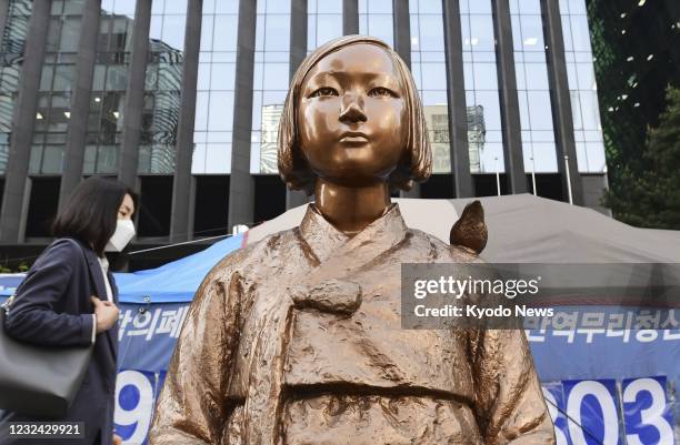 Statue symbolizing "comfort women" forced to work in Japanese wartime military brothels is pictured on April 21 in front of the Japanese embassy in...