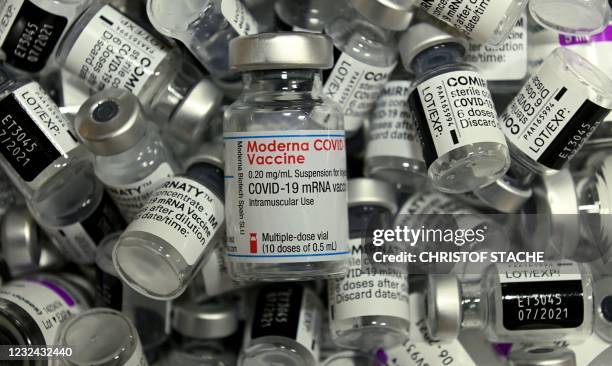 Empty vials of different vaccines by Moderna, Pfizer-BioNTech and AstraZeneca against Covid-19 caused by the novel coronavirus are pictured at the...