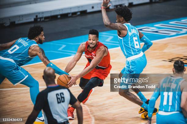 McCollum of the Portland Trail Blazers dribbles the ball against the Charlotte Hornets on April 18, 2021 at Spectrum Center in Charlotte, North...