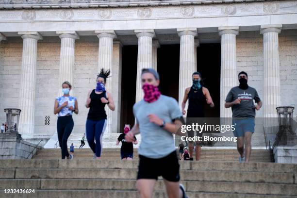 People wear protective masks while exercising at the Lincoln Memorial in Washington, D.C., U.S., on Wednesday, April 21, 2021. Senate Republicans...