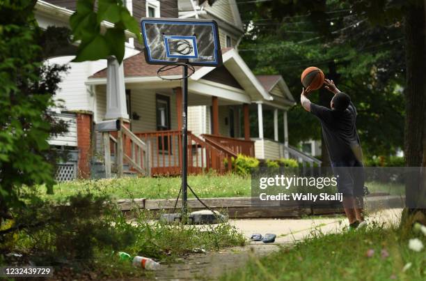 Demetrius Skipper plays basketball on a street in Akron, Ohio and the town where LeBron James grew up as a child.