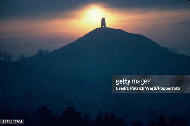 Sunrise at Glastonbury Tor with its tower, the only remains of the 15th century St Michael's church, circa May 1985.