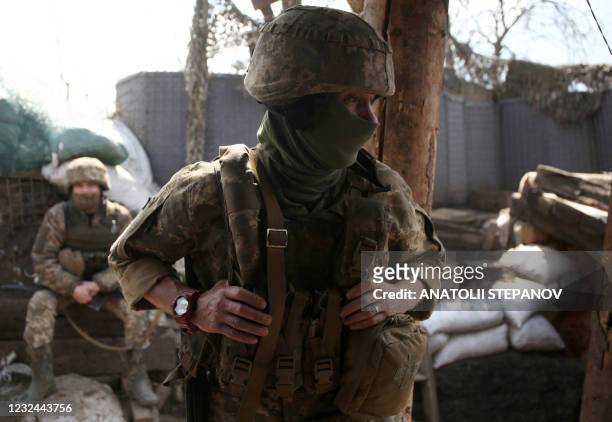 Ukrainian servicemen stand at a position on the frontline with Russia-backed separatists near Gorlivka, Donetsk region, on April 21, 2021. -...