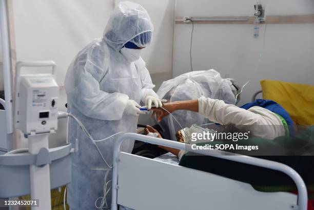 Health worker wearing Personal Protective Equipment attending to patients at the field hospital in Menzah district, a sports complex that was...