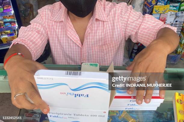 In this picture taken on April 20 a member of staff sorts boxes of Fabiflu tablets, an anti-viral medicine containing favipiravir and used to treat...