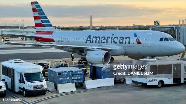 An American Airlines plane is seen at sunrise on the tarmac of the Reagan Washington National Airport in Arlington, Virginia, on April 22, 2021.
