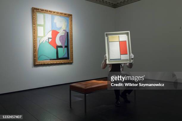 Staff member poses with 'Femme Assise Pres d'une Fenetre' oil on canvas by Pablo Picasso , property of an important private collector, estimate on...