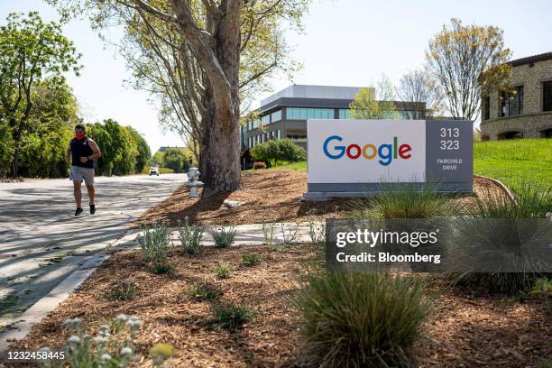 Person wearing a protective masks runs past a Google campus in Mountain View, California, U.S., on Wednesday, April 21, 2021. Silicon Valley has the...