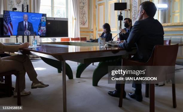 French President Emmanuel Macron listens to US President Joe Biden speak during a virtual Earth Day Climate Summit, video conference call, at the...