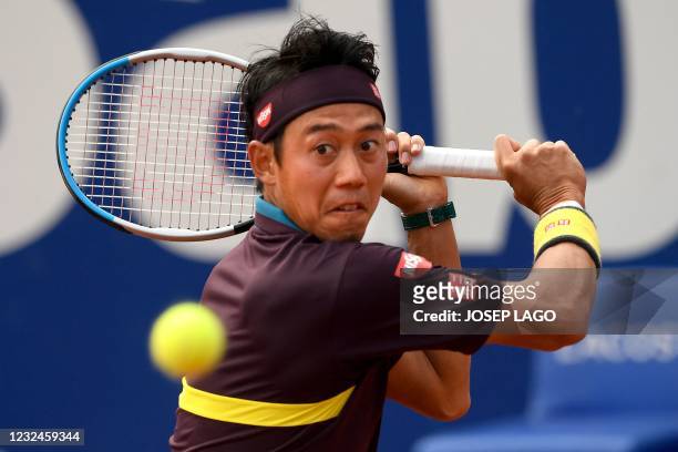 Japan's Kei Nishikori returns the ball to Spain's Rafael Nadal during their ATP Barcelona Open tennis tournament singles match at the Real Club de...