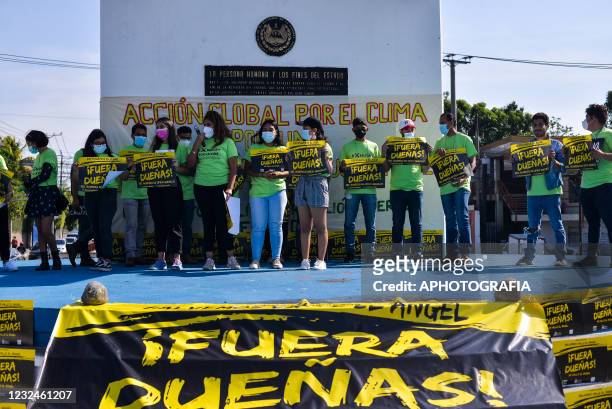 Activists hold up signs while protesting against the constructions of a commercial complex that received a water relief contract as part of global...