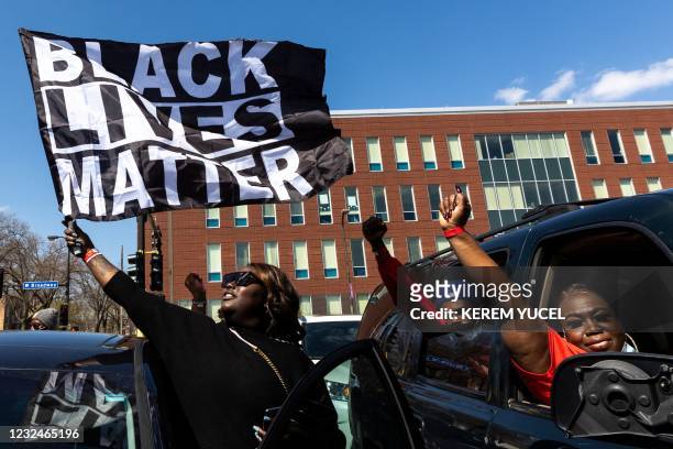 Woman holds a Black Lives Matter flag during the funeral service of Daunte Wright outside the Shiloh Temple International Ministries in Minneapolis,...