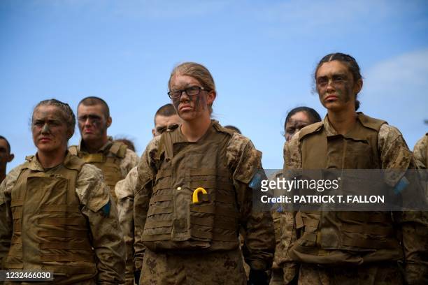 United States Marine Corps recruits from Lima Company, the first gender integrated training class in San Diego, read a medal citation before body...