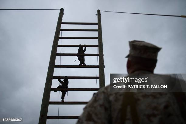 United States Marine Corps recruits from Lima Company, the first gender integrated training class in San Diego, climb up an obstacle course during...