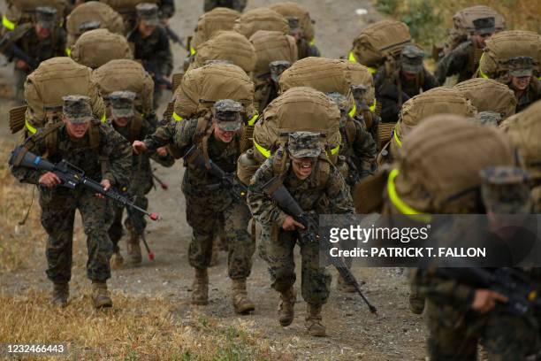 Female United States Marine Corps recruits from Lima Company, the first gender integrated training class in San Diego complete their 9.7 mile hike on...
