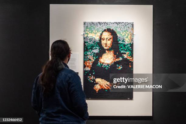 Visitor looks at a re-creation of the "Mona Lisa" by brick artist Nathan Sawaya during the "The Art of The Brick" exhibit, April 22, 2021 at the...