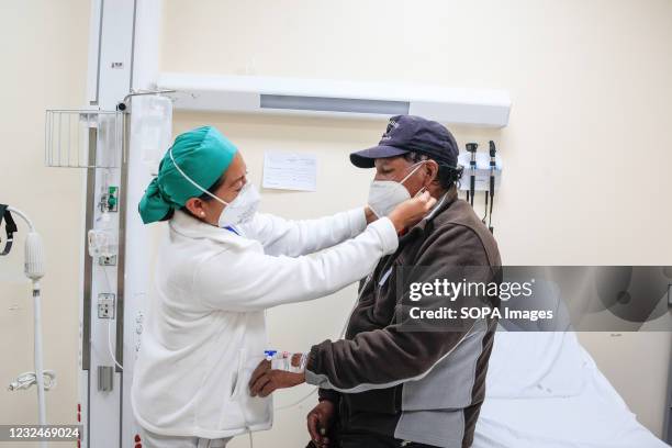 Nurse adjusts the face mask of a patient infected by covid19 during the pandemic. In the South IESS Hospital , different spaces have had to be...