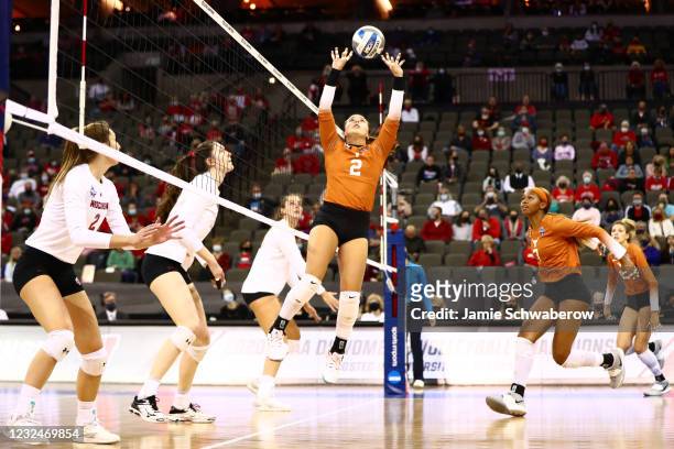 Jhenna Gabriel of the Texas Longhorns hits a set against the Wisconsin Badgers during the Division I Women's Volleyball Semifinals held at the Chi...