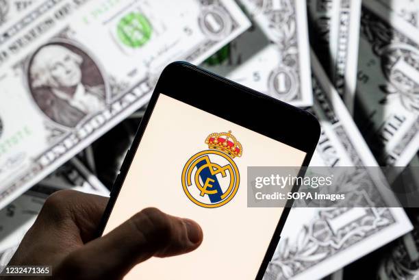 In this photo illustration Spanish professional football club team Real Madrid Club de Fútbol commonly known as Real Madrid logo seen on an Android...
