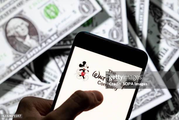 In this photo illustration American multinational mass media and entertainment The Walt Disney Company or also called Disney logo seen on an Android...