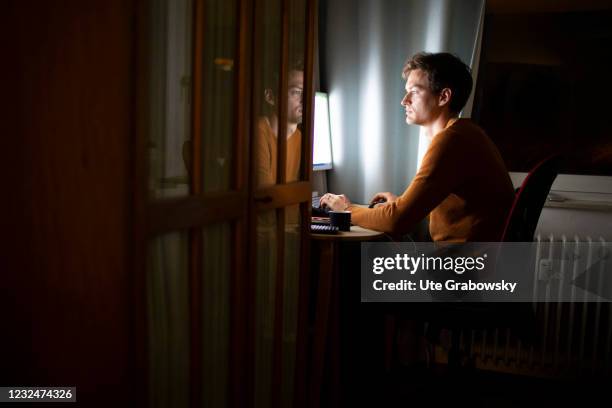 Bonn, Germany In this photo illustration a man is working on computer at night on April 20, 2021 in Bonn, Germany.