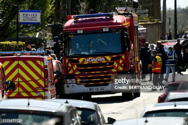 Firefighters stand near a police station in Rambouillet, south-west of Paris, on April 23 after a woman was stabbed to death in the town. - A female...