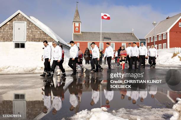Members of Inatsisartut leave Vor Frue church in Nuuk and walk towards the Inatsisartut parliament building at the spring assembly in the the...