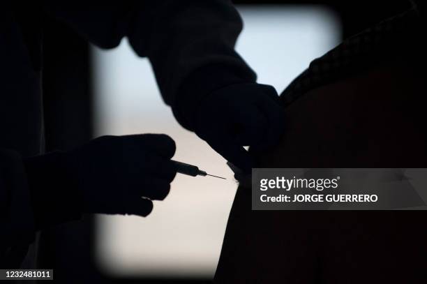 Man receives a dose of the single-dose Johnson & Johnson Janssen Covid-19 vaccine at a vaccine rollout targetting elderly people in Ronda on April...