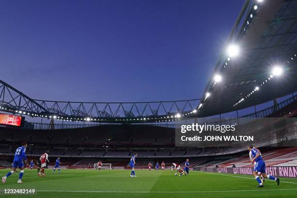 Players compete for the ball under the floodlights during the English Premier League football match between Arsenal and Everton at the Emirates...