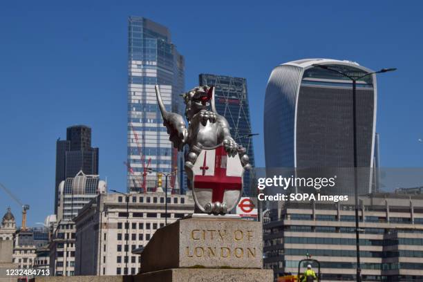 Dragon boundary mark and the City of London skyline on a clear day.