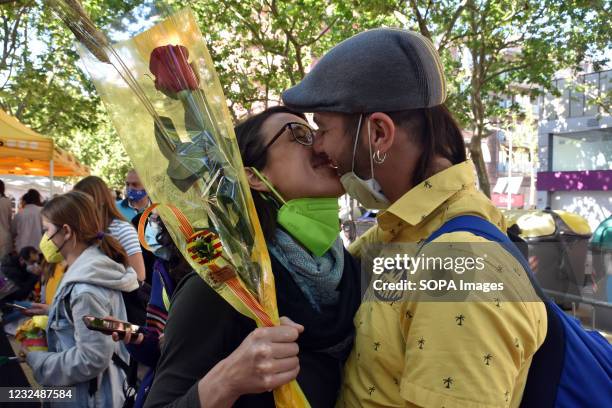 Couple kisses after receiving their gifts in L´Hospitalet during the feast of Saint George. April 23 is Saint George's Day its a tradition in...