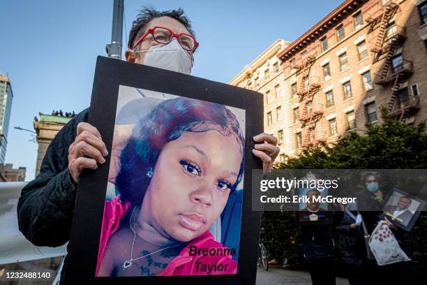 Participant seen holding a protrait of Breonna Taylor at the silent protest. Members of the activist group Rise And Resist gathered at 96th Street...