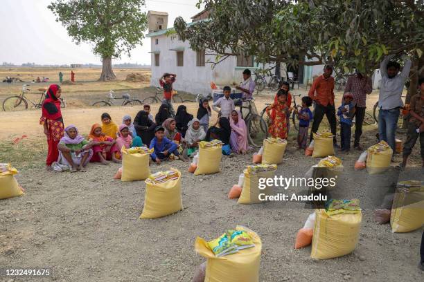 People receive food packages delivered by Turkey' Diyanet Foundation during the holy month of Ramadan in Nepal's Kathmandu on April 21, 2021