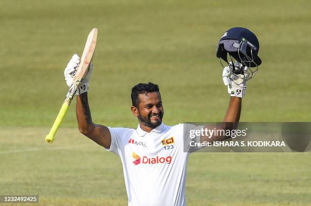 Sri Lanka's Dimuth Karunaratne celebrates after scoring a double century during the fourth day of the first Test cricket match between Sri Lanka and...
