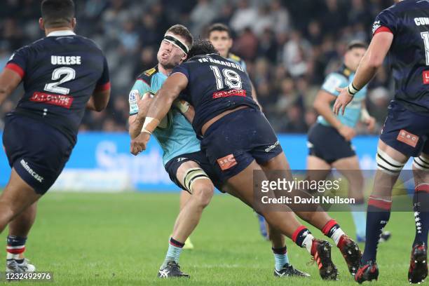 Max Douglas of the Waratahs is hit with a tackle from Pone Fa'amausili of the Rebels, who received a red card for the foul during the round 10 Super...