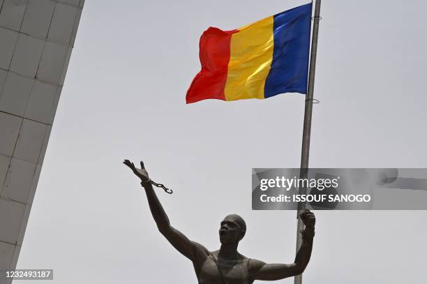 This picture taken in N'djamena on April 23, 2021 shows the Chad flag floating on a monument at the 'Place de la Nation' during the late president...