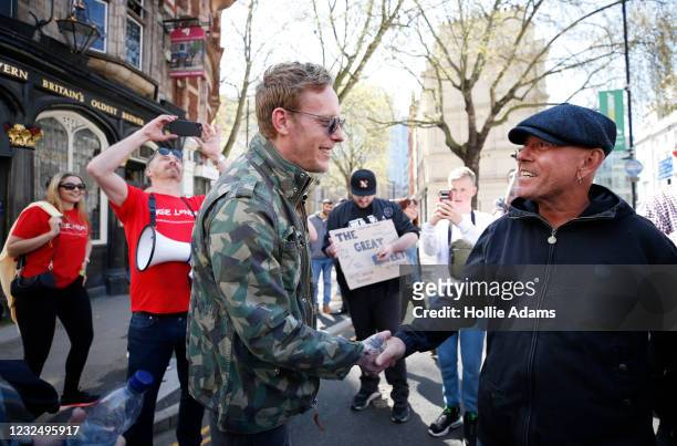 London mayoral candidate Laurence Fox shakes hands with a protester as he attends a "Unite For Freedom" anti-lockdown demonstration held to protest...