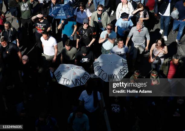 Protesters carry umbrellas saying "No to Vaxx Passport" during a "Unite For Freedom" anti-lockdown demonstration held to protest against the use of...