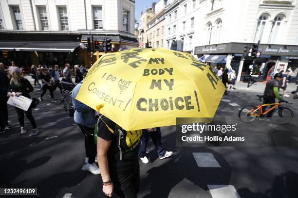Protester carries an umbrella that says "My Body My Choice" in reference to COVID-19 vaccinations, during a "Unite For Freedom" anti-lockdown...