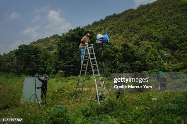 Production crew prepares the spot lights for the filming of ÒTearless,Ó virtual reality film by Gina Kim, at an abandoned building known by the...