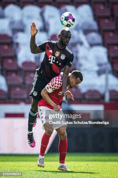 Tanguy Nianzou of Munich and Robin Quaison of Mainz in action during the Bundesliga match between 1. FSV Mainz 05 and FC Bayern München at Opel Arena...