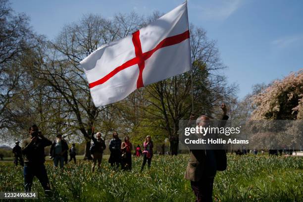 Protester holds a St George's flag during a "Unite For Freedom" anti-lockdown demonstration held to protest against the use of vaccine passports in...