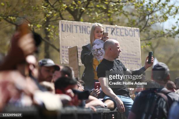 Protestor holding a Bill Gates mask takes a photo of other protestors during a "Unite For Freedom" anti-lockdown demonstration held to protest...