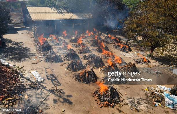 Multiple funeral pyres of people who died of Covid-19 burning simultaneously at Gazipur crematorium on April 24, 2021 in New Delhi, India.