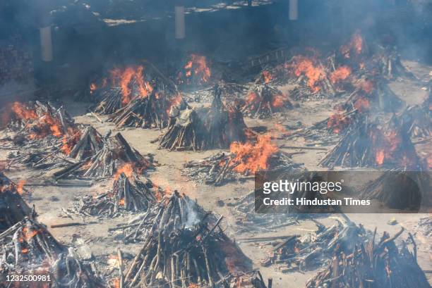 Multiple funeral pyres of people who died of Covid-19 burning simultaneously at Gazipur crematorium on April 24, 2021 in New Delhi, India.